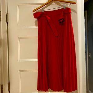 Pleated tea length skirt. Red. Never worn